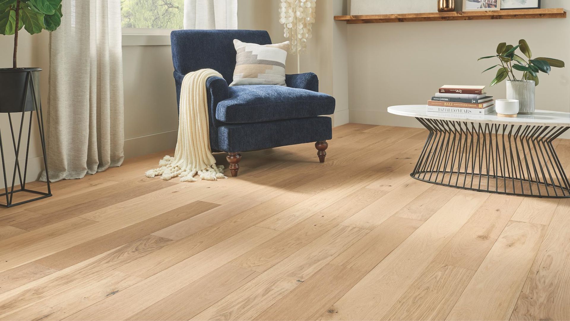 light toned hardwood floors in a bright sitting area with chair and coffee table